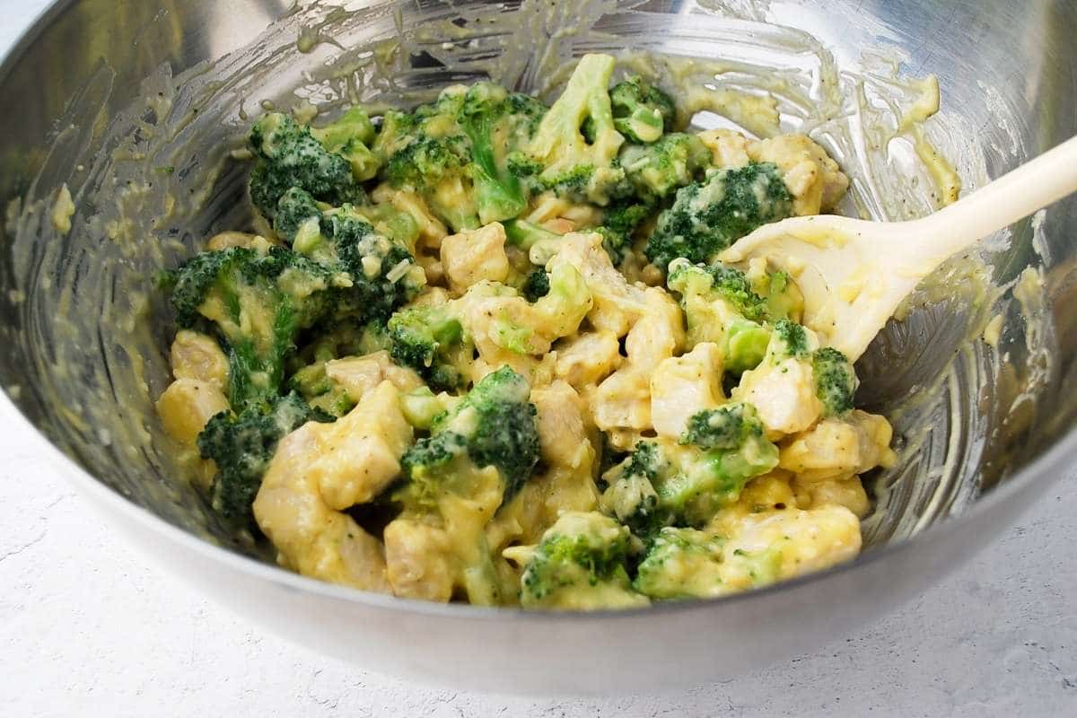 chicken broccoli casserole ingredients mixed in a bowl