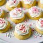 iced thumbprint cookies on a platter with peppermint crunch