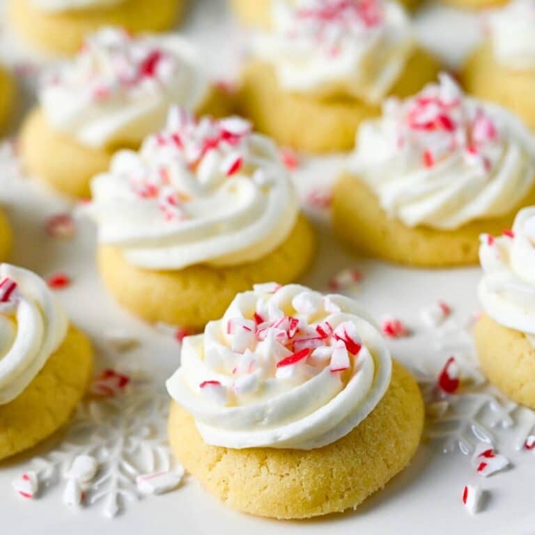 a platter of thumbprint cookies with peppermint buttercream and crushed candy canes