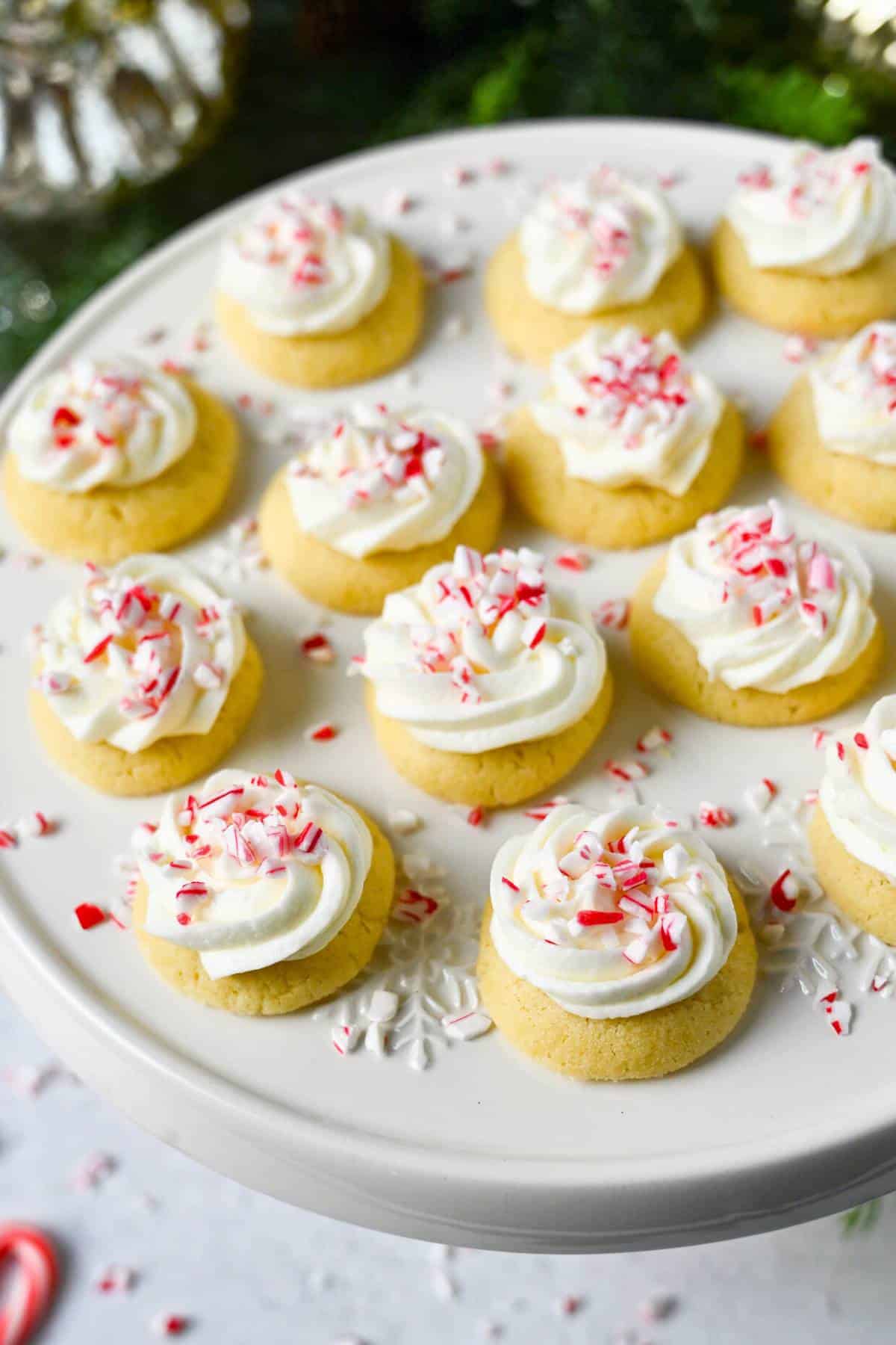 a platter of peppermint thumbprint cookies with candy cane pieces on top