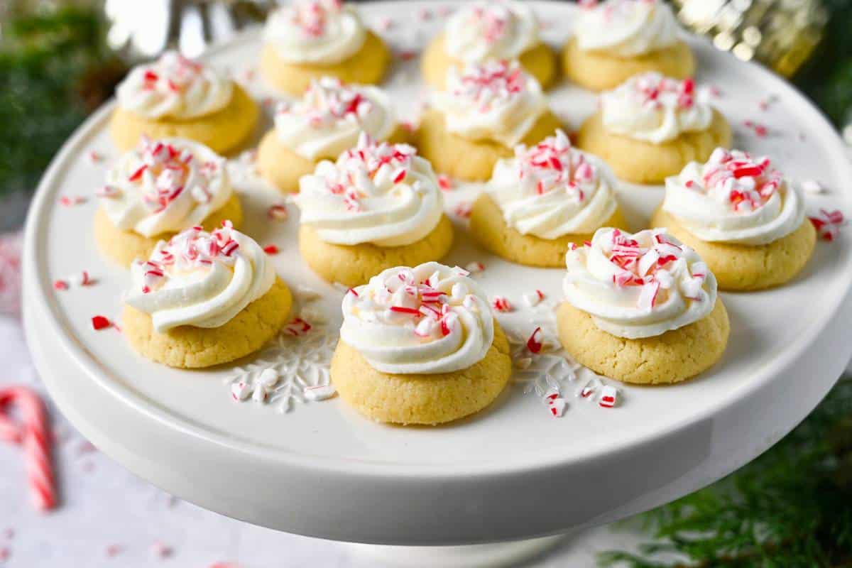 side view of a platter of Christmas thumbprint cookies with peppermint