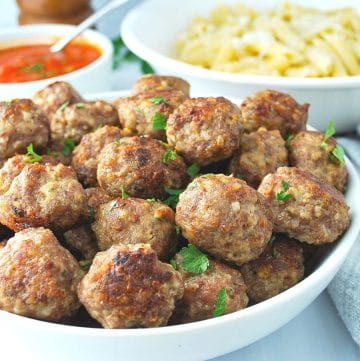 gluten free meatballs in a bowl sprinkled with fresh parsley