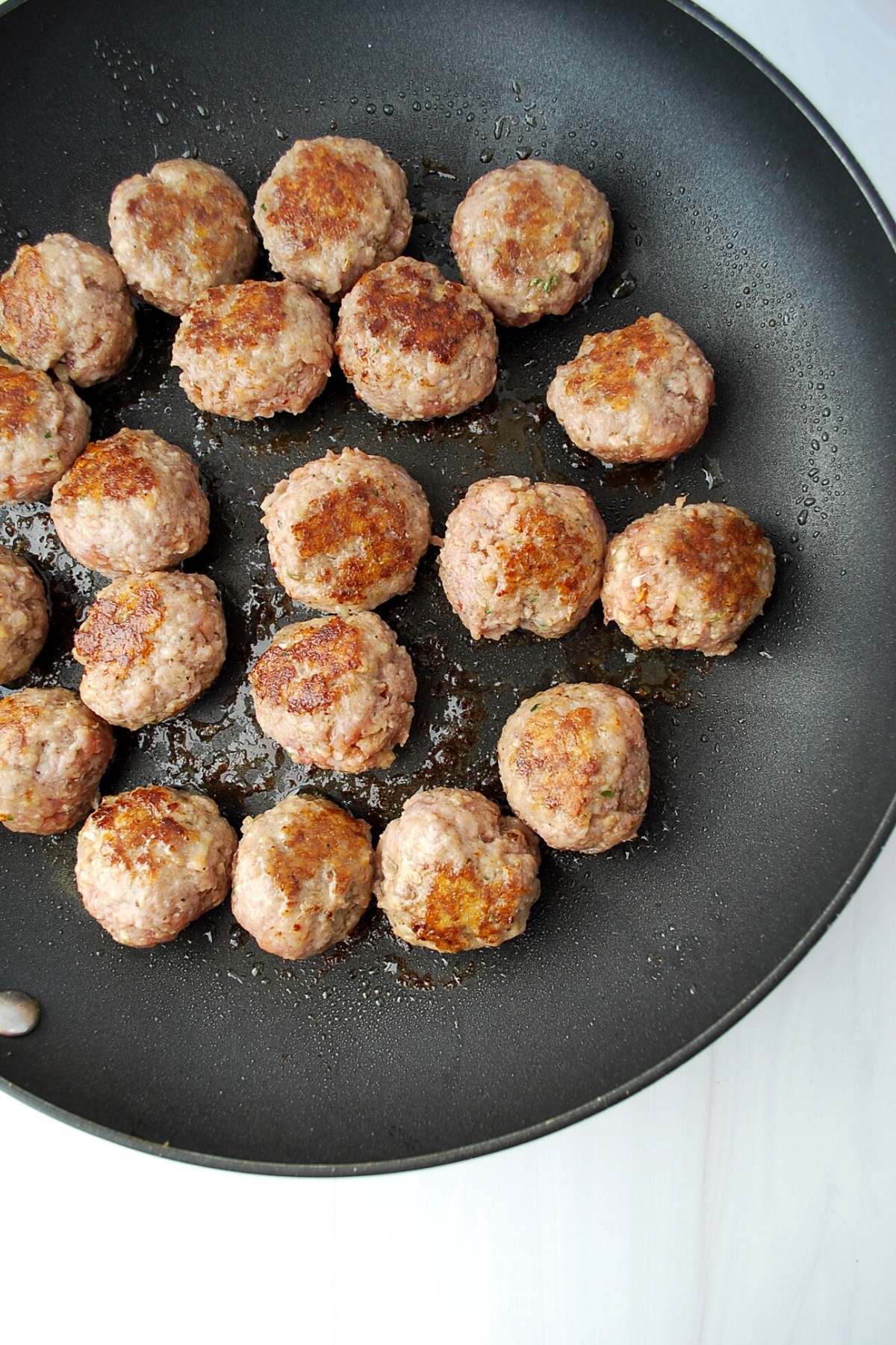 browned meatballs in a frying pan