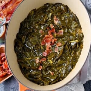 overhead view of collard greens with bacon in a dutch oven