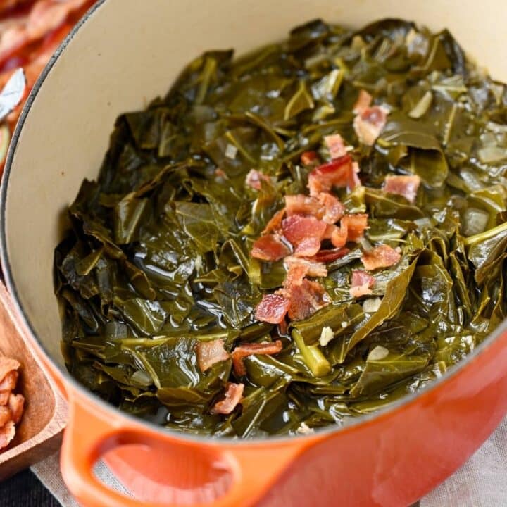 a pot of braised collard greens topped with crumbled bacon