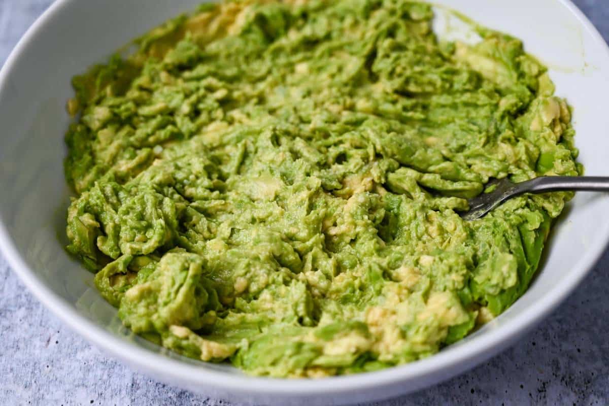 mashed avocado in a shallow bowl 