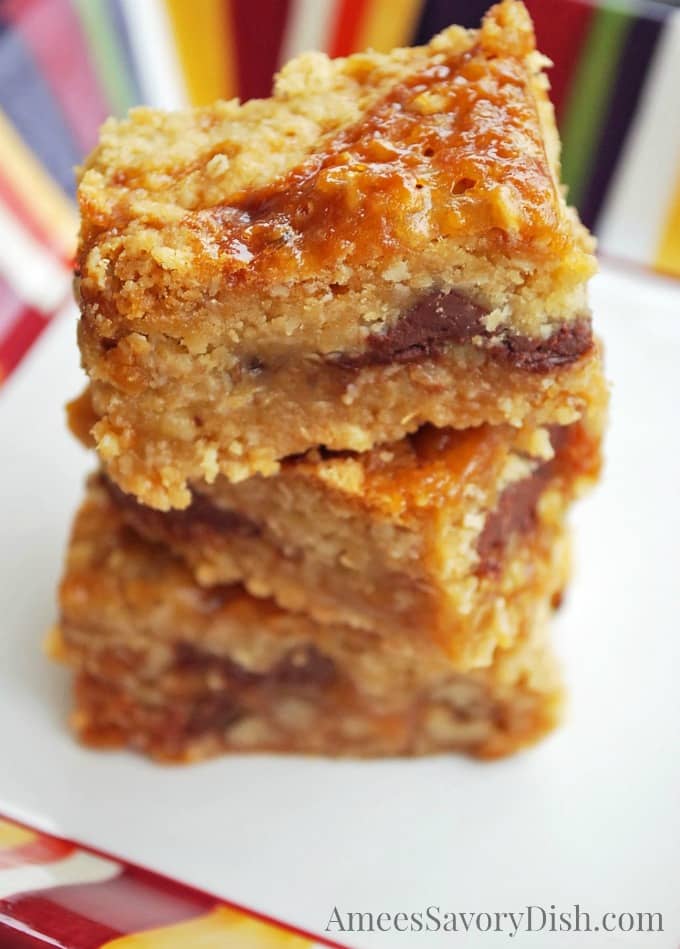 Three Gluten-Free Oatmeal Carmelita bars stacked on a plate