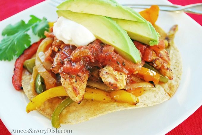 Easy Grilled Chicken Fajitas cooking on a grill topped on a tostada shell