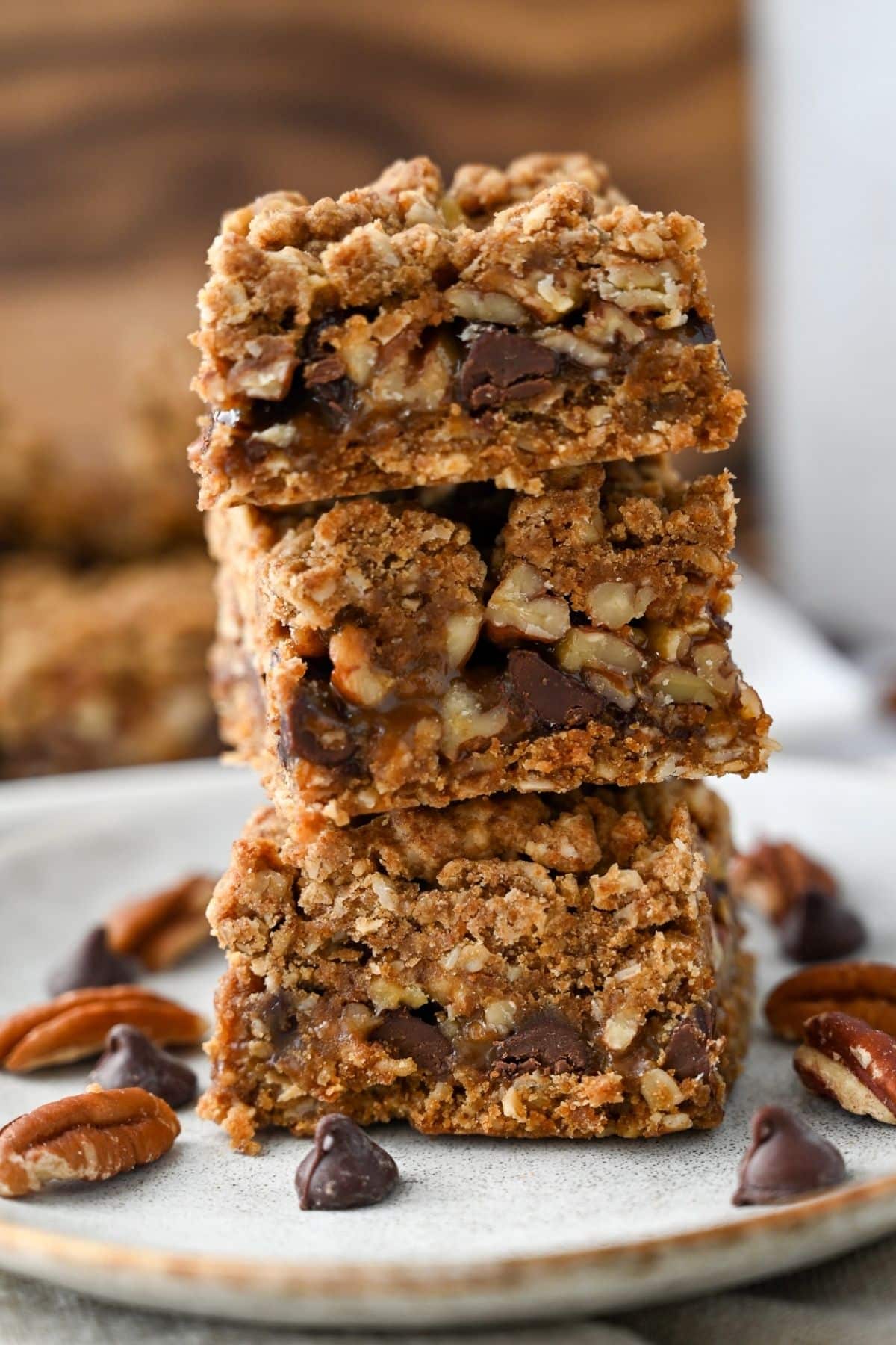 a stack of gf carmelita bars with pecans and chocolate chips