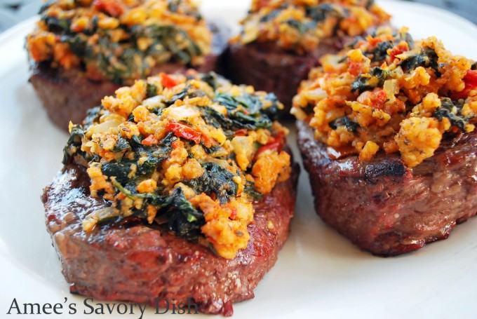 Steaks on a plate topped with spinach feta mixture
