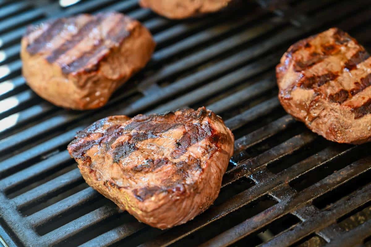 sirloin steak cooking on the grill