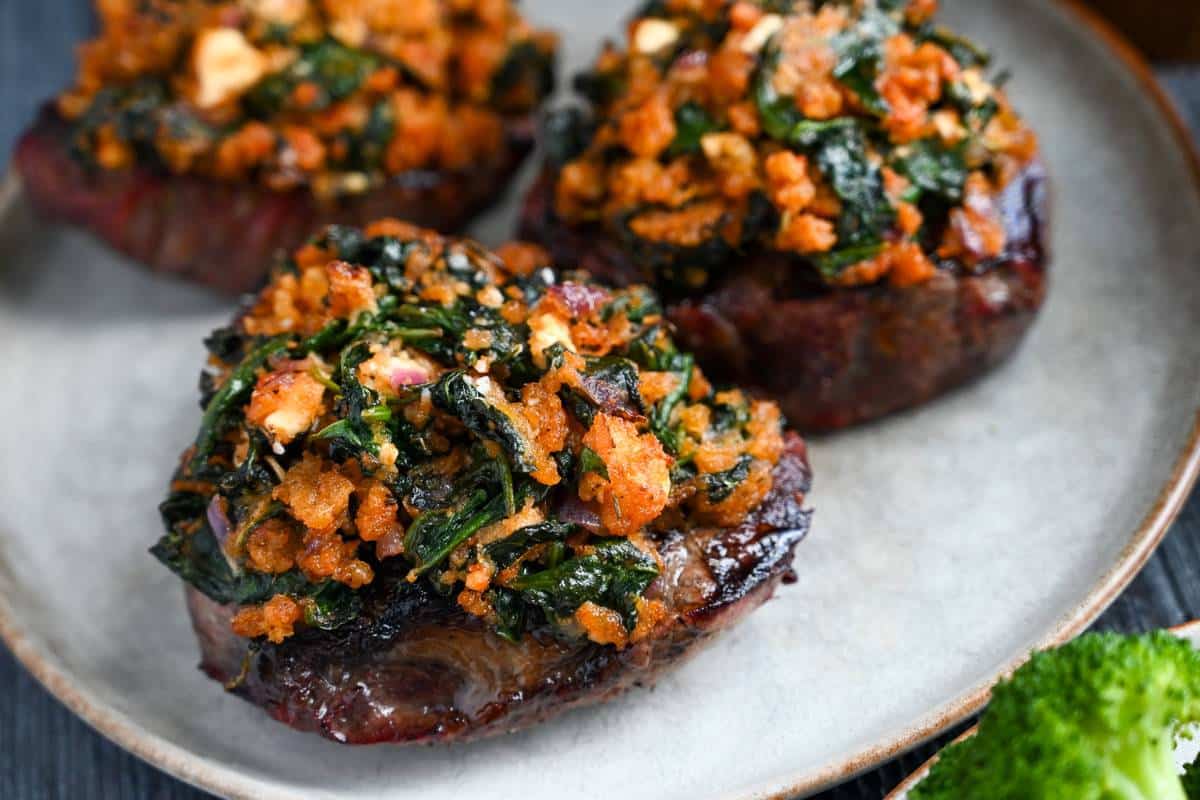 sirloin steak topped with a spinach feta mixture that has been cooked under a broiler
