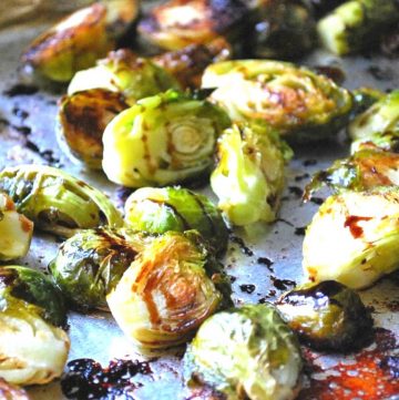 pan of roasted brussels sprouts drizzled with balsamic vinegar