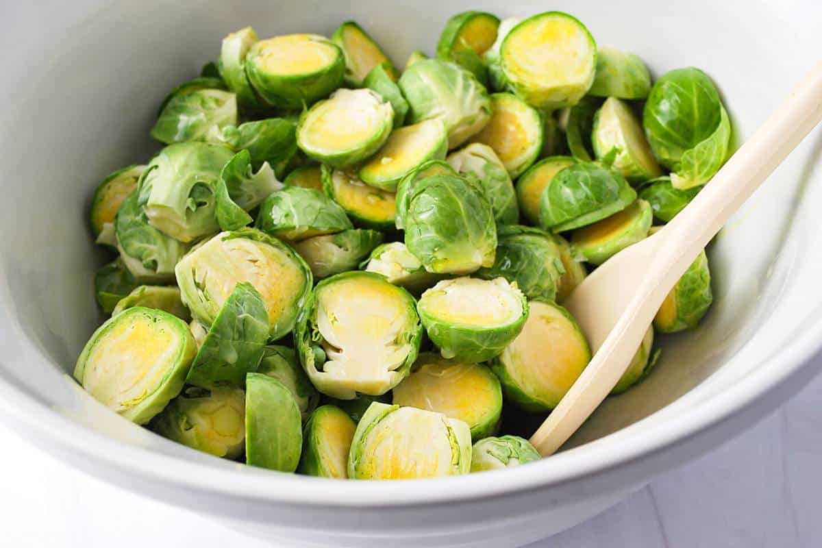 brussels sprouts cut in half in a white bowl