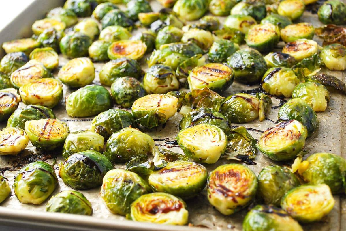 roasted brussels sprouts ready to serve on a baking sheet