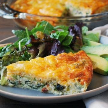 plate of quiche with salad and avocado