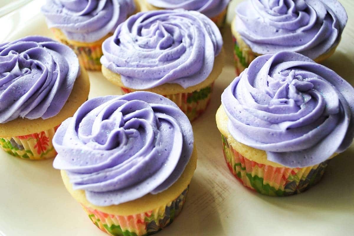 lavender cupcakes on a cream plate with swirled purple hued icing