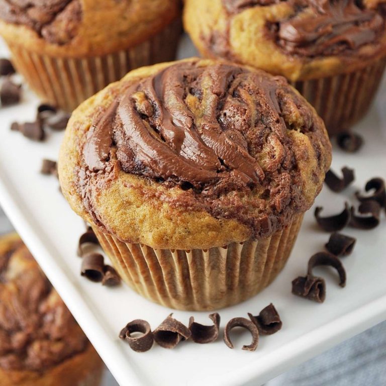 close up of nutella muffin on a plate with chocolate shavings around it