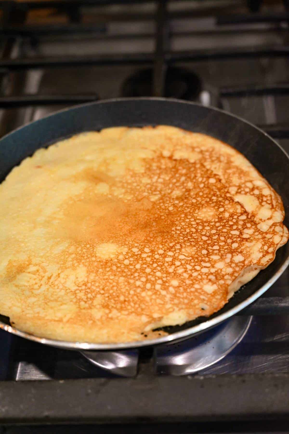 a crepe cooked in a skillet