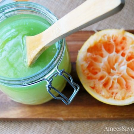 Sugar scrub and half a grapefruit on a wooden board