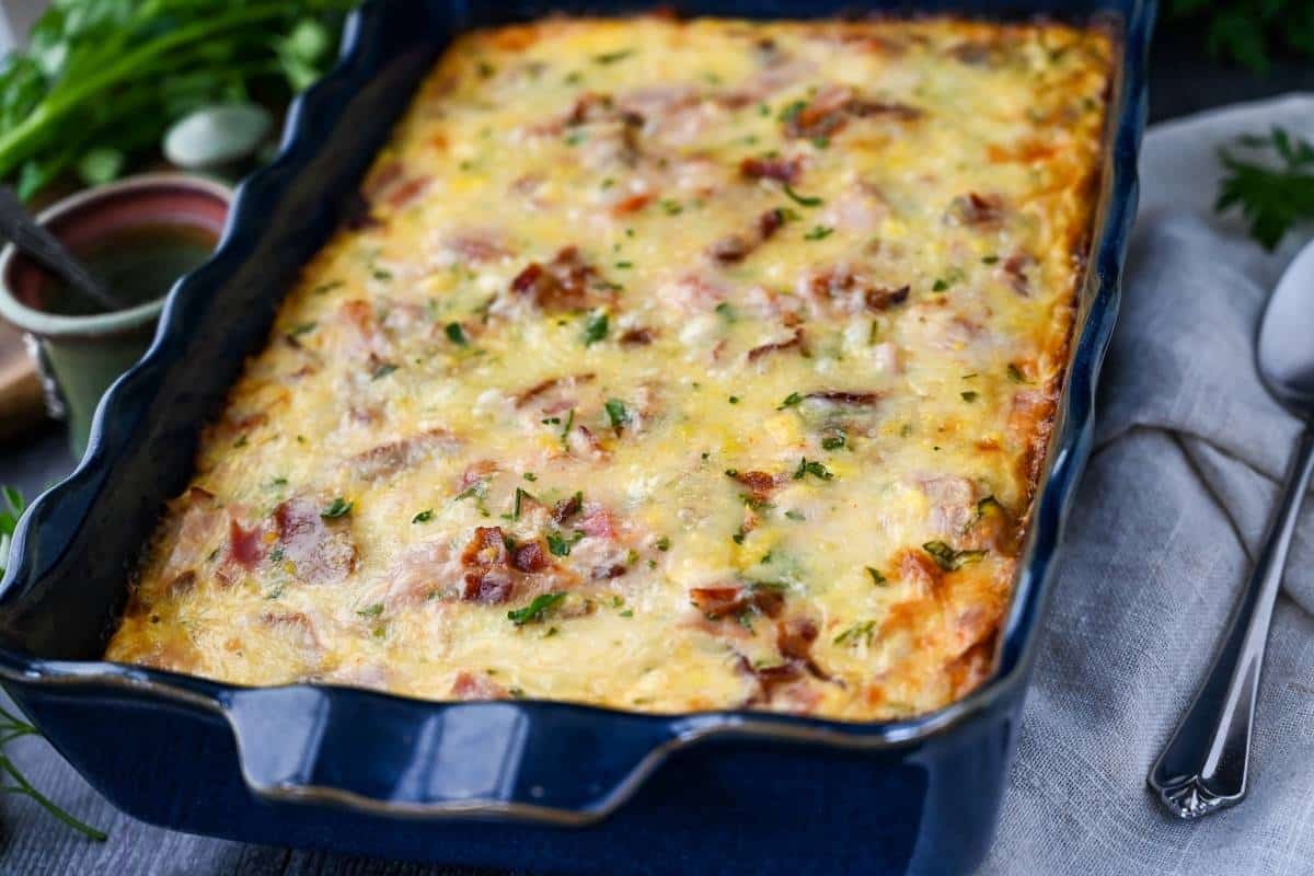 side view of a loaded casserole for breakfast in a blue dish