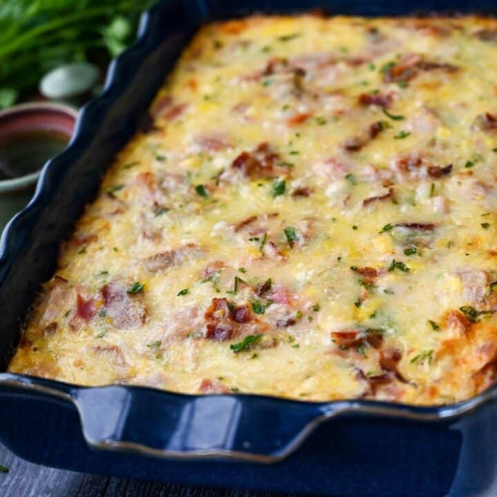 side view of a loaded breakfast casserole with bacon, ham and potatoes