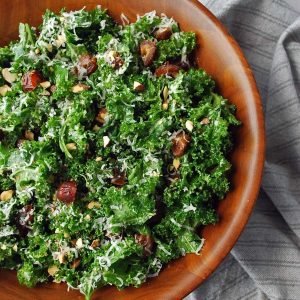 close up of a large serving bowl of kale crunch salad with dates and Parmesan