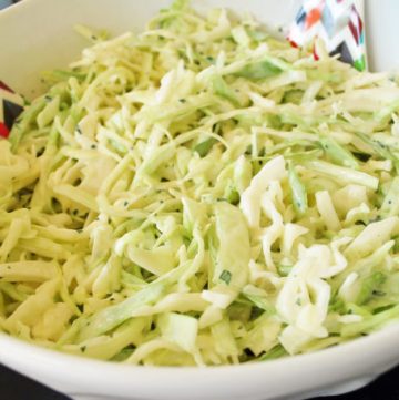 bowl of lime healthy slaw with serving spoons