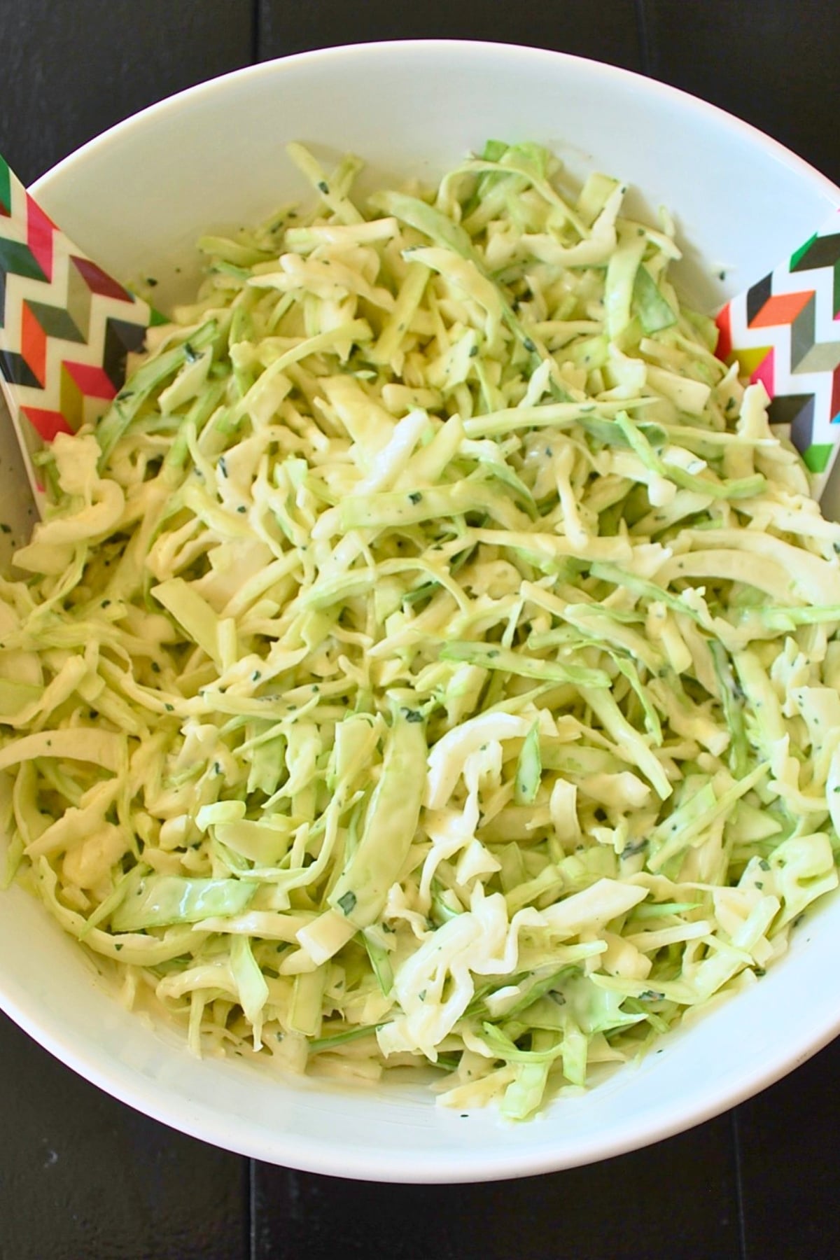 a bowl of slaw with spoons