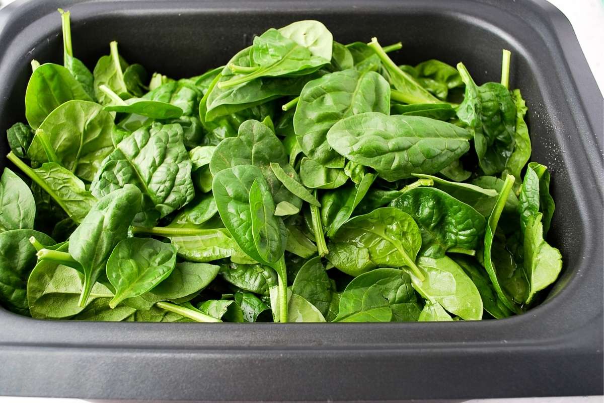 ingredients for chicken bean soup with spinach in a slow cooker