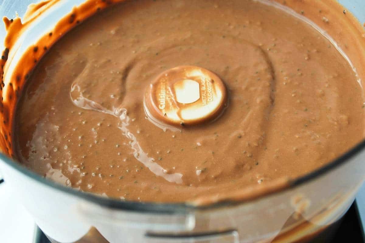 chia seeds added to chocolate pudding in a food processor