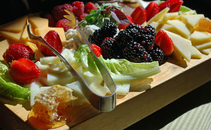 Fruit platter with honeycomb, cheese and assorted berries