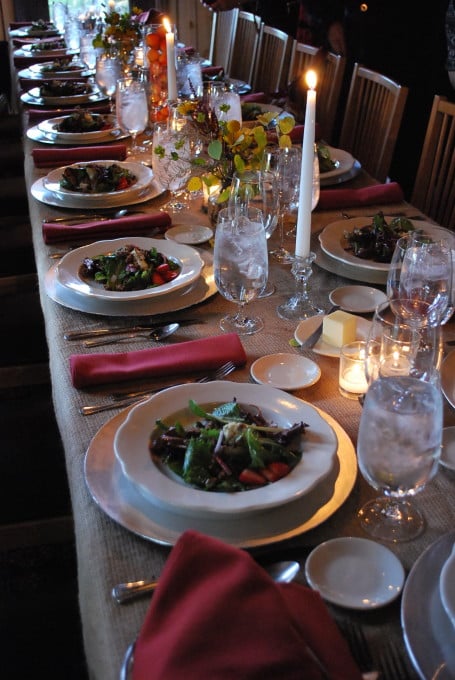 Table setting with plates of food and candles