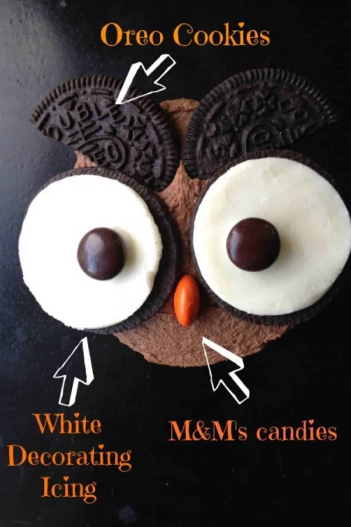 a single owl cupcakes made with oreos and m&ms