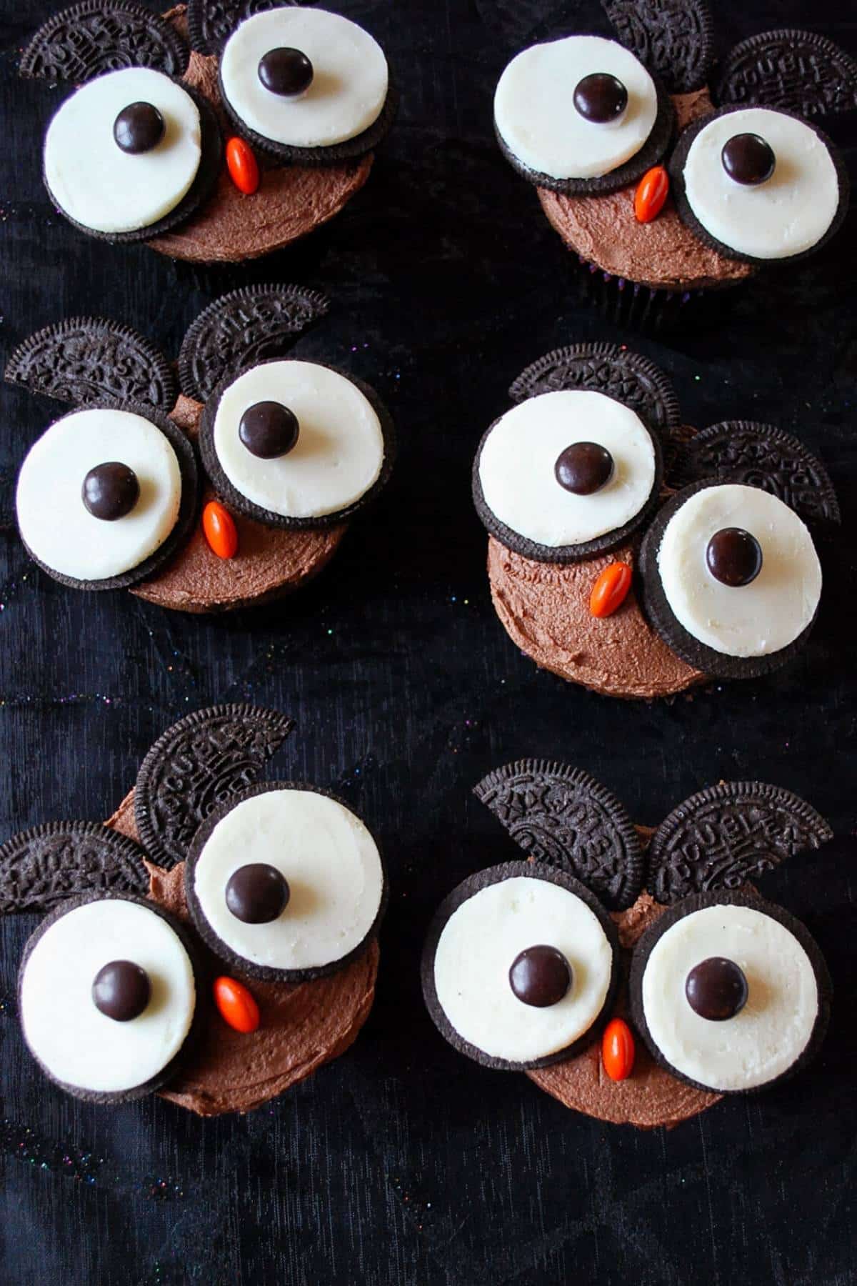 owl cupcakes on a black tablecloth