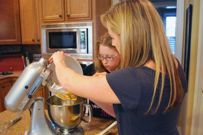 A woman preparing food in a kitchen