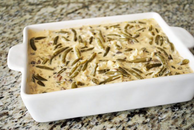green bean casserole in a baking dish ready to cook