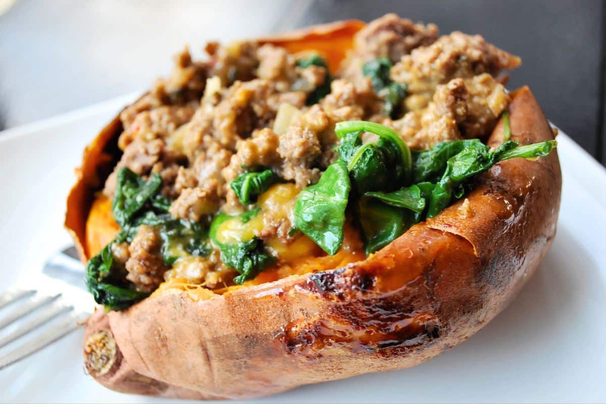 a sweet potato stuffed with a lean sausage, cheese, and kale filling