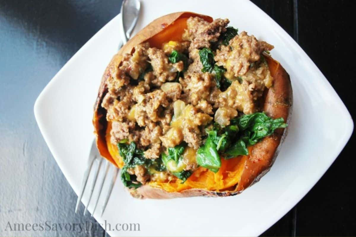 a stuffed sweet potato on a plate with a fork