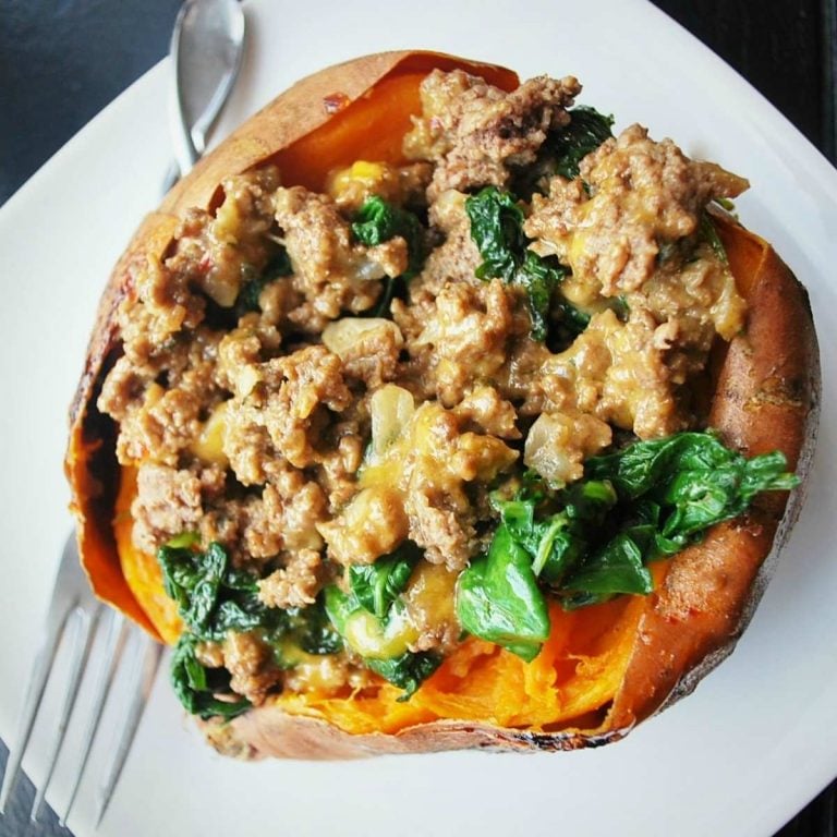 overhead photo of a cooked sweet potato with a beef and spinach filling