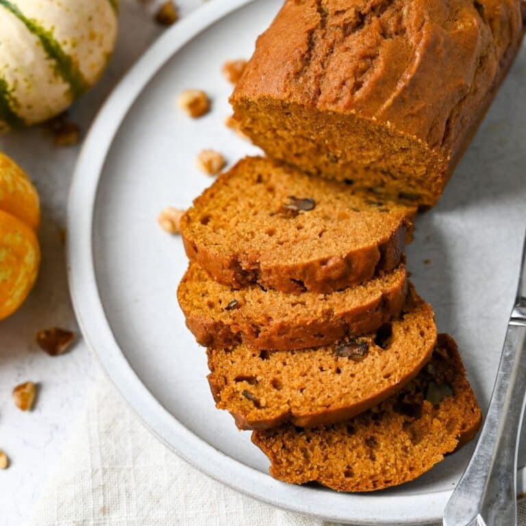 sliced pumpkin walnut bread on a plate