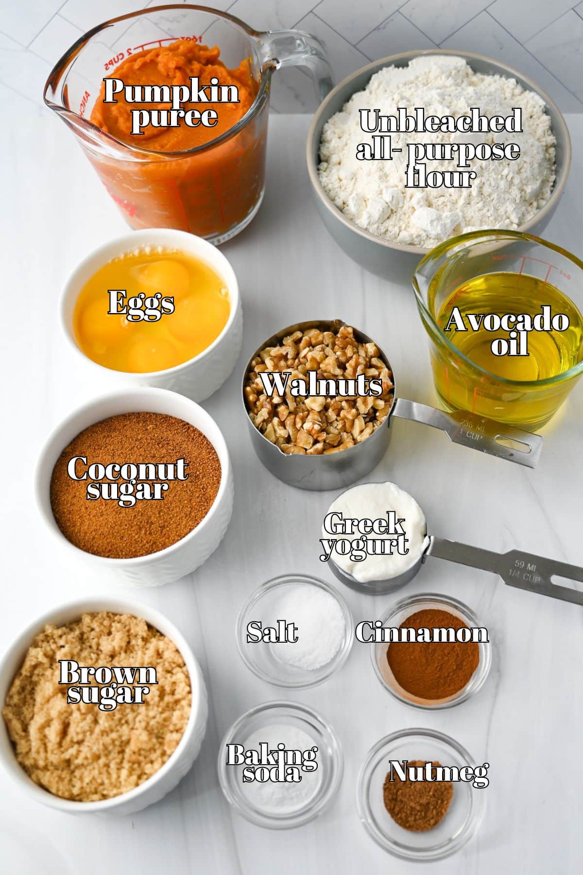 ingredients measured out on the counter for pumpkin bread and labeled for the photo