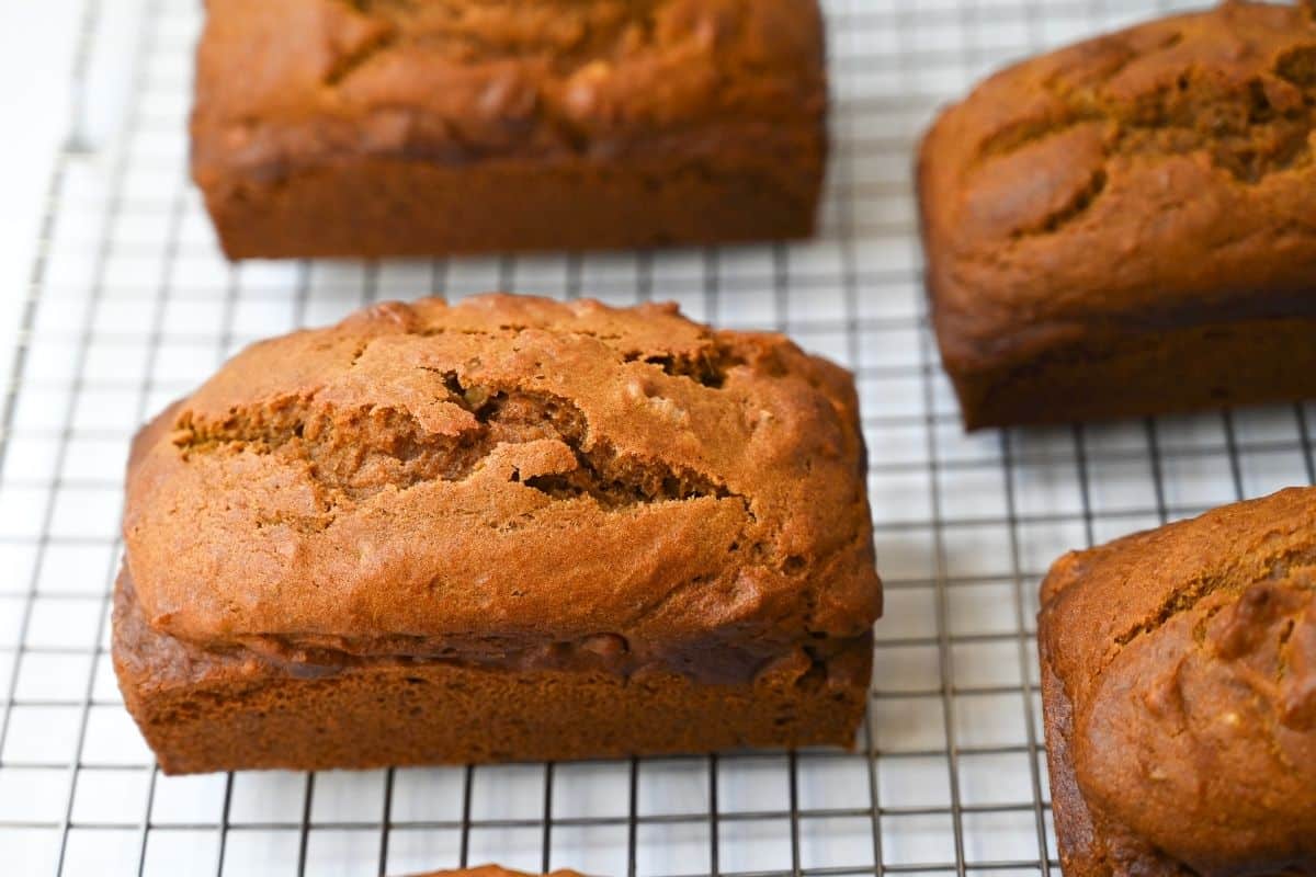 mini baked loaves of pumpkin walnut bread on a cooling rack