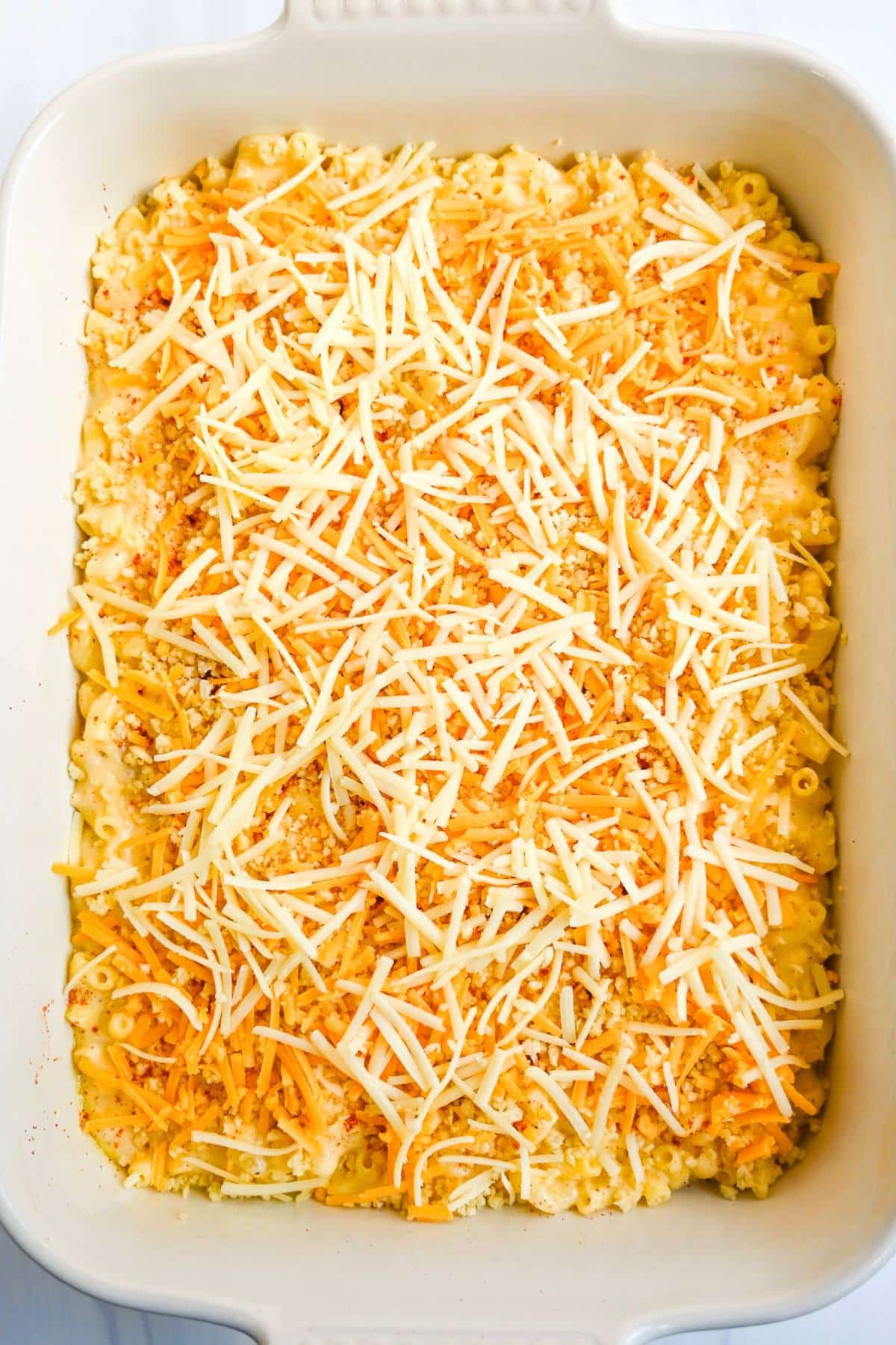 mac and cheese in a casserole dish ready to bake