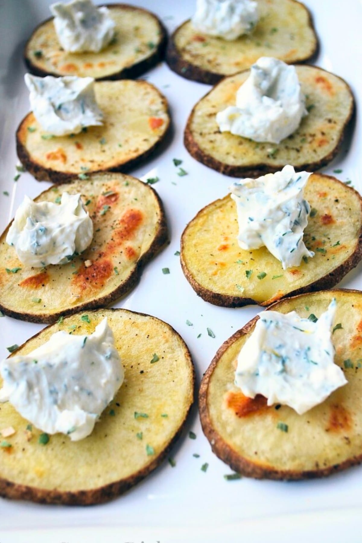 yogurt on top of sliced roasted potato rounds