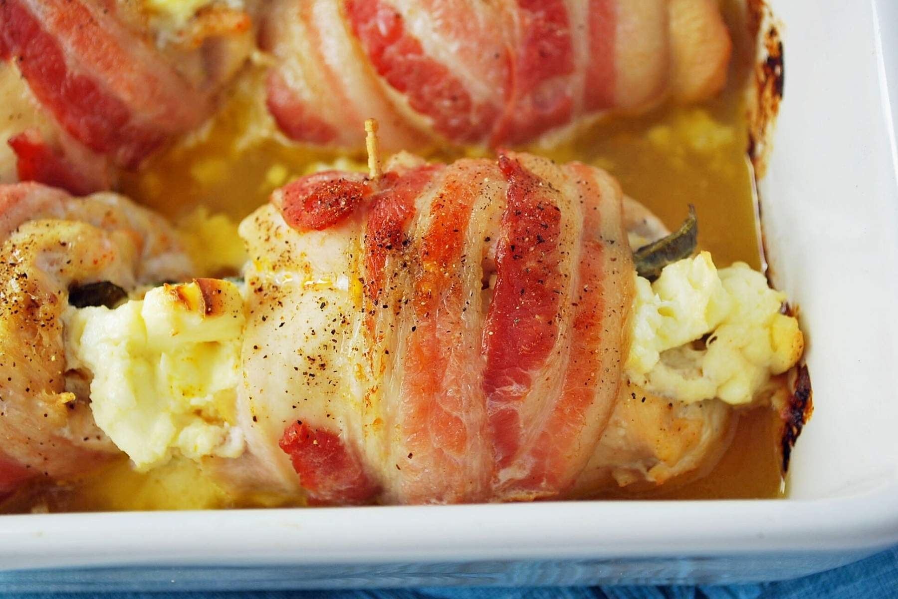 bacon-wrapped chicken breasts in a baking dish just cooked