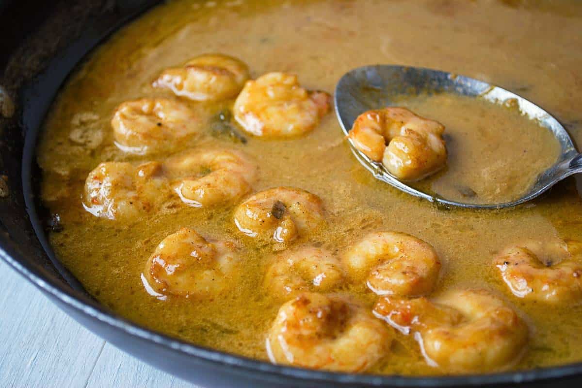 cooked shrimp in a cajun style sauce in a skillet