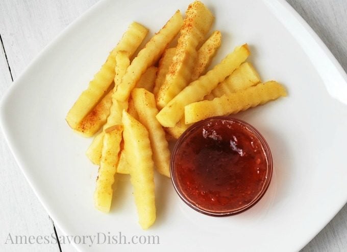 Overhead photo of apple fries on a plate with jam on the side