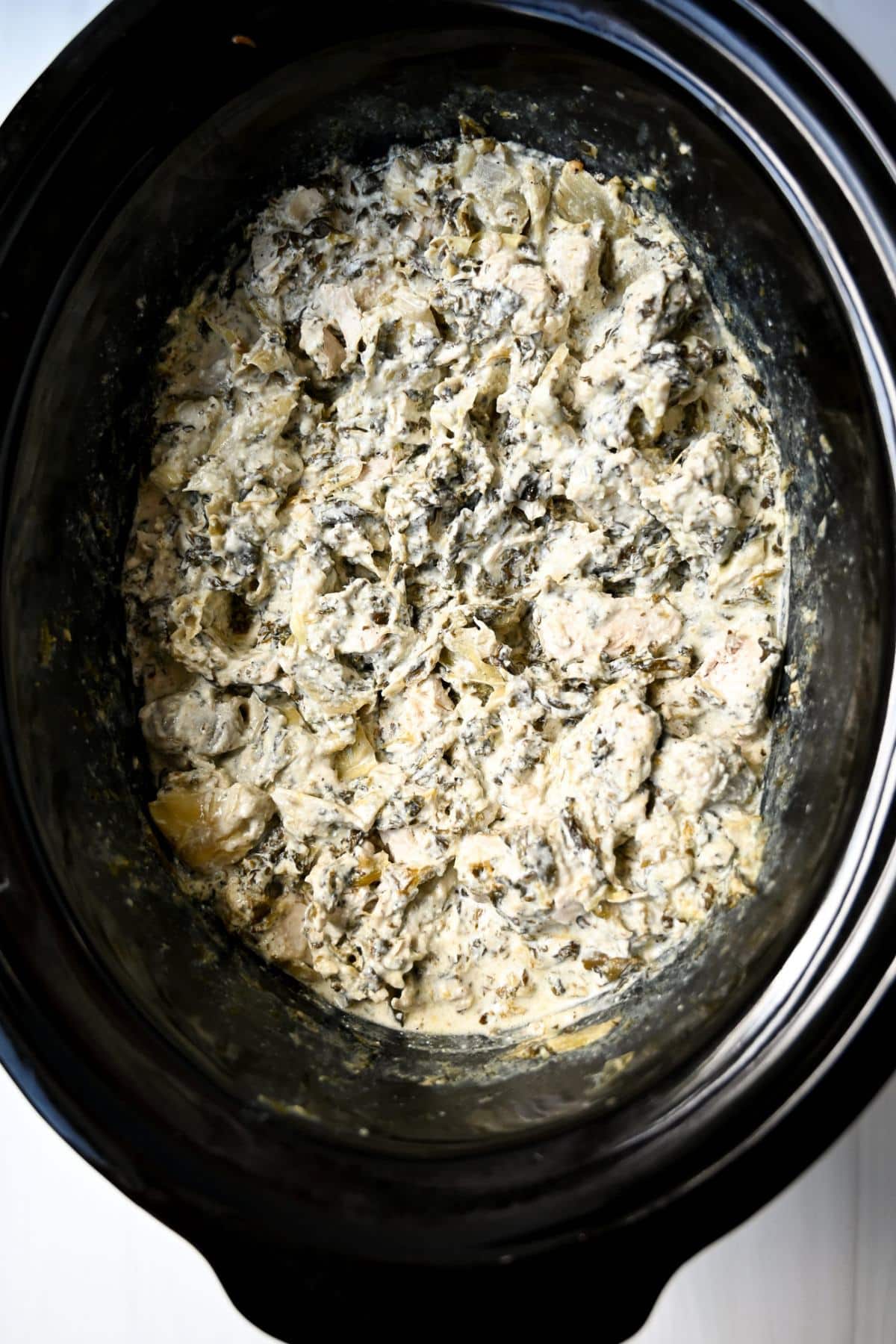 creamy chicken with frozen spinach and artichokes cooked in a slow cooker 