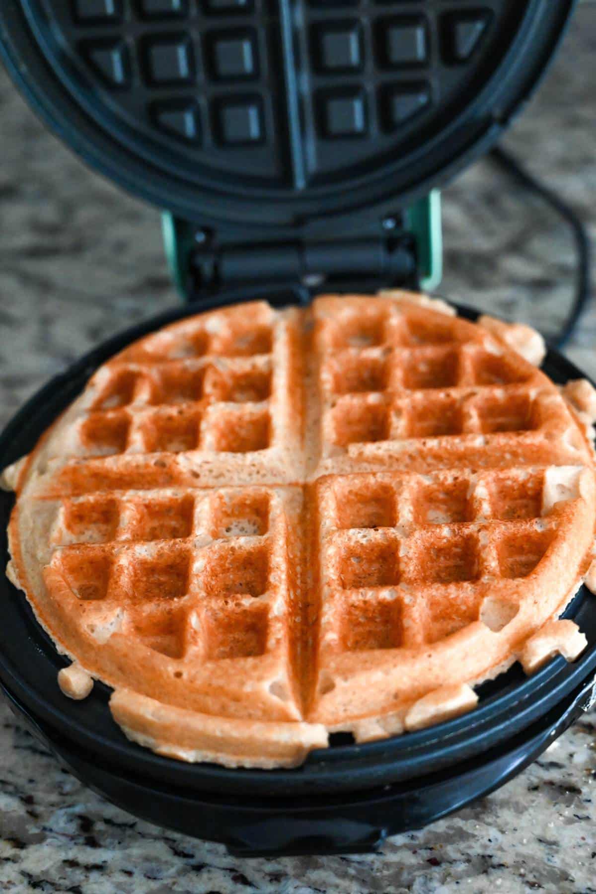 cooked waffle in a waffle iron